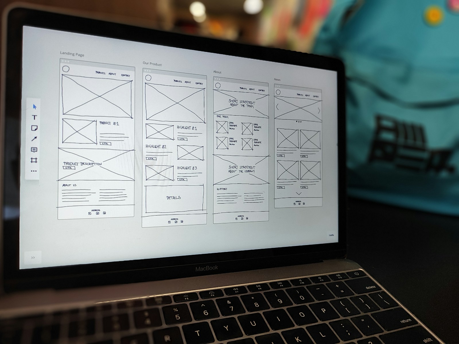 Website wireframe displayed on a laptop on a clean office desk