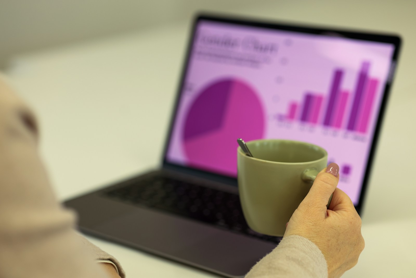 Person reviewing colourful advertising and analytics charts on a laptop