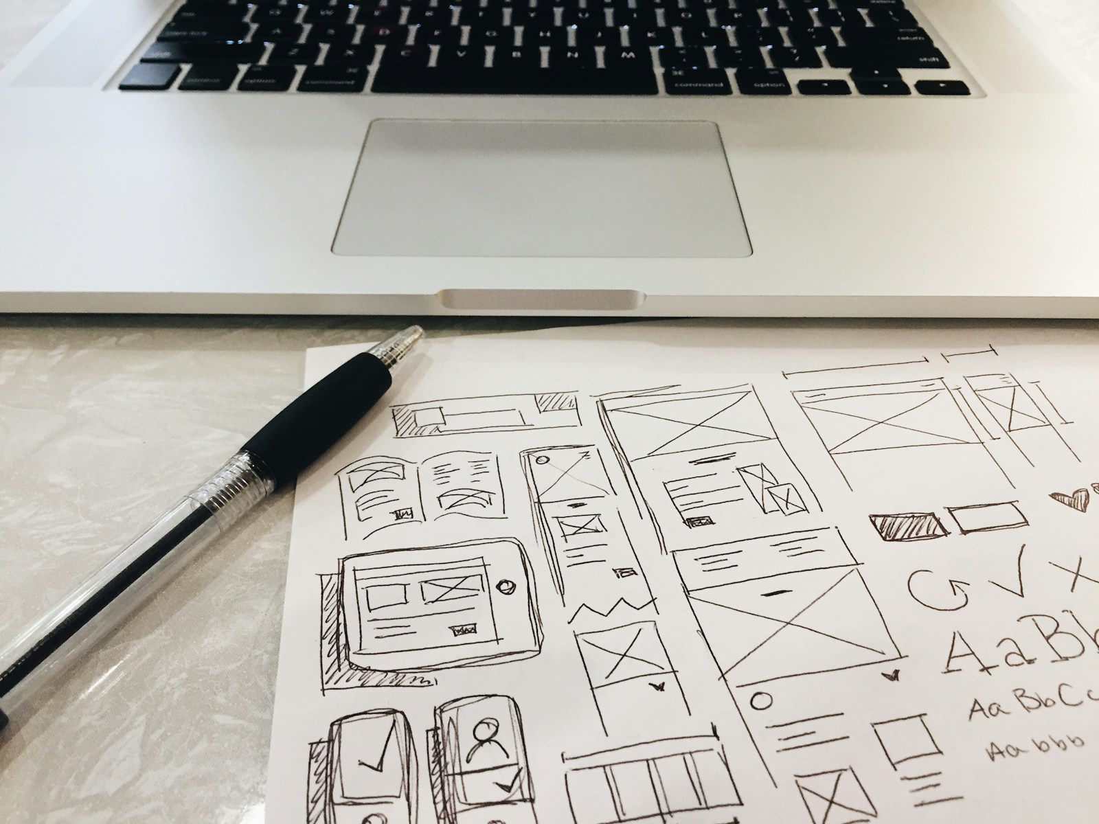 Laptop, pen, and planning notes on a desk before a website redesign