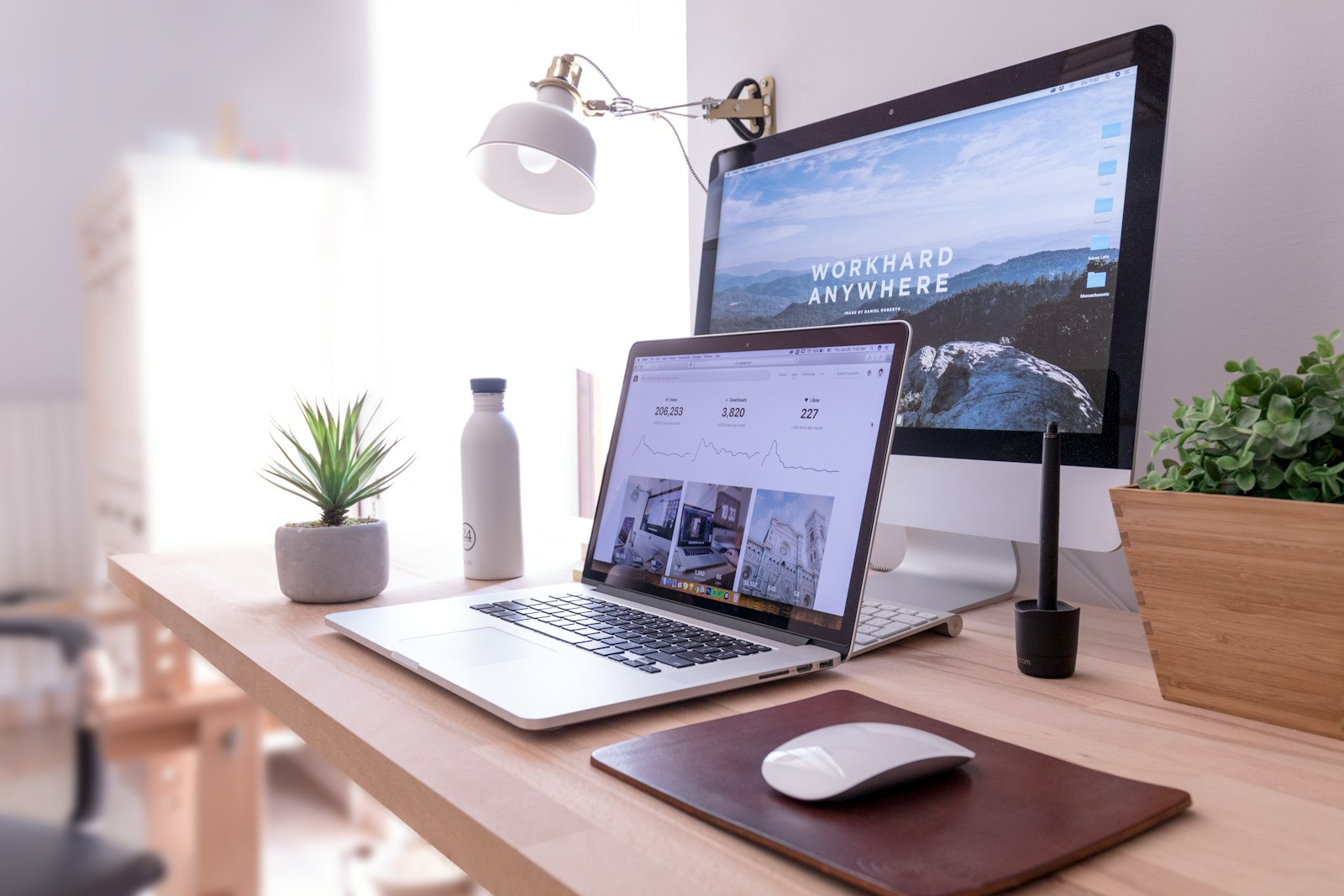 Clean dual-monitor workstation showing a polished professional website setup