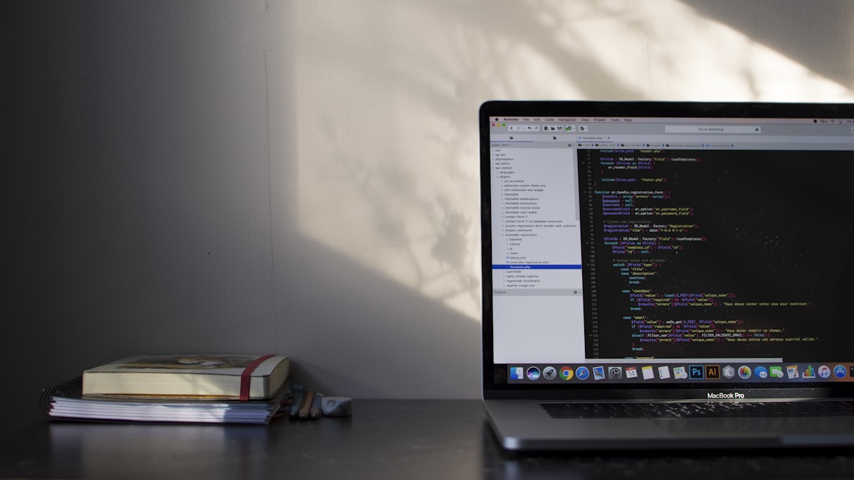 MacBook displaying modern programming code on a clean desk