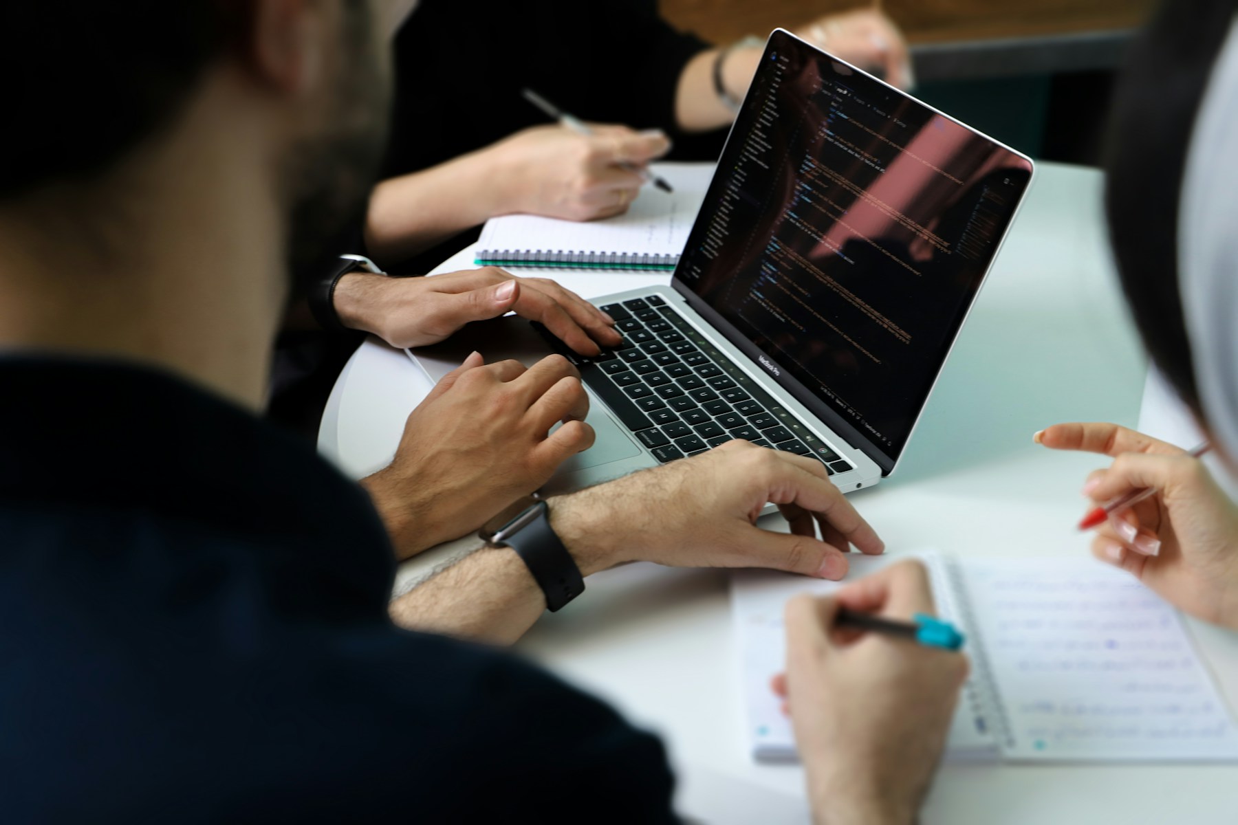 Business team reviewing a website plan together around a laptop