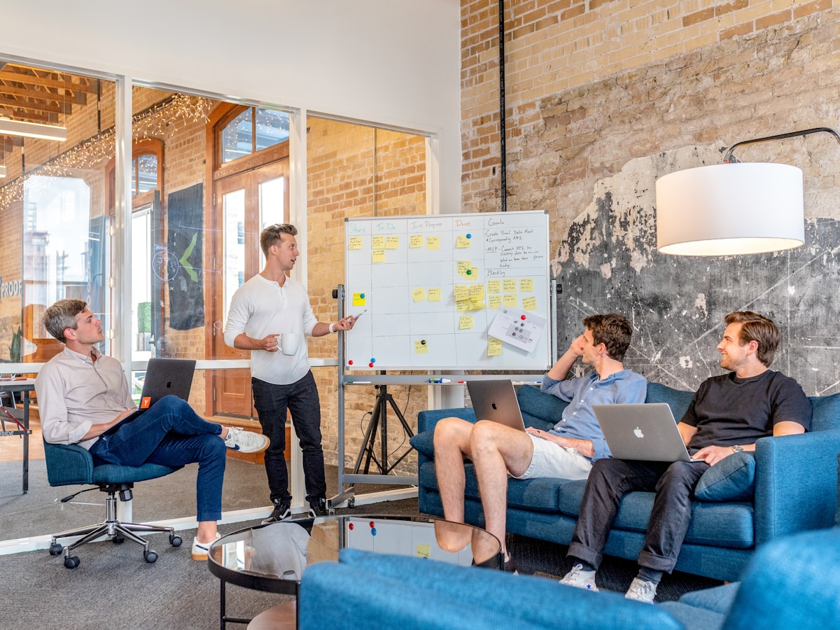 Software team collaborating around a whiteboard in a modern office